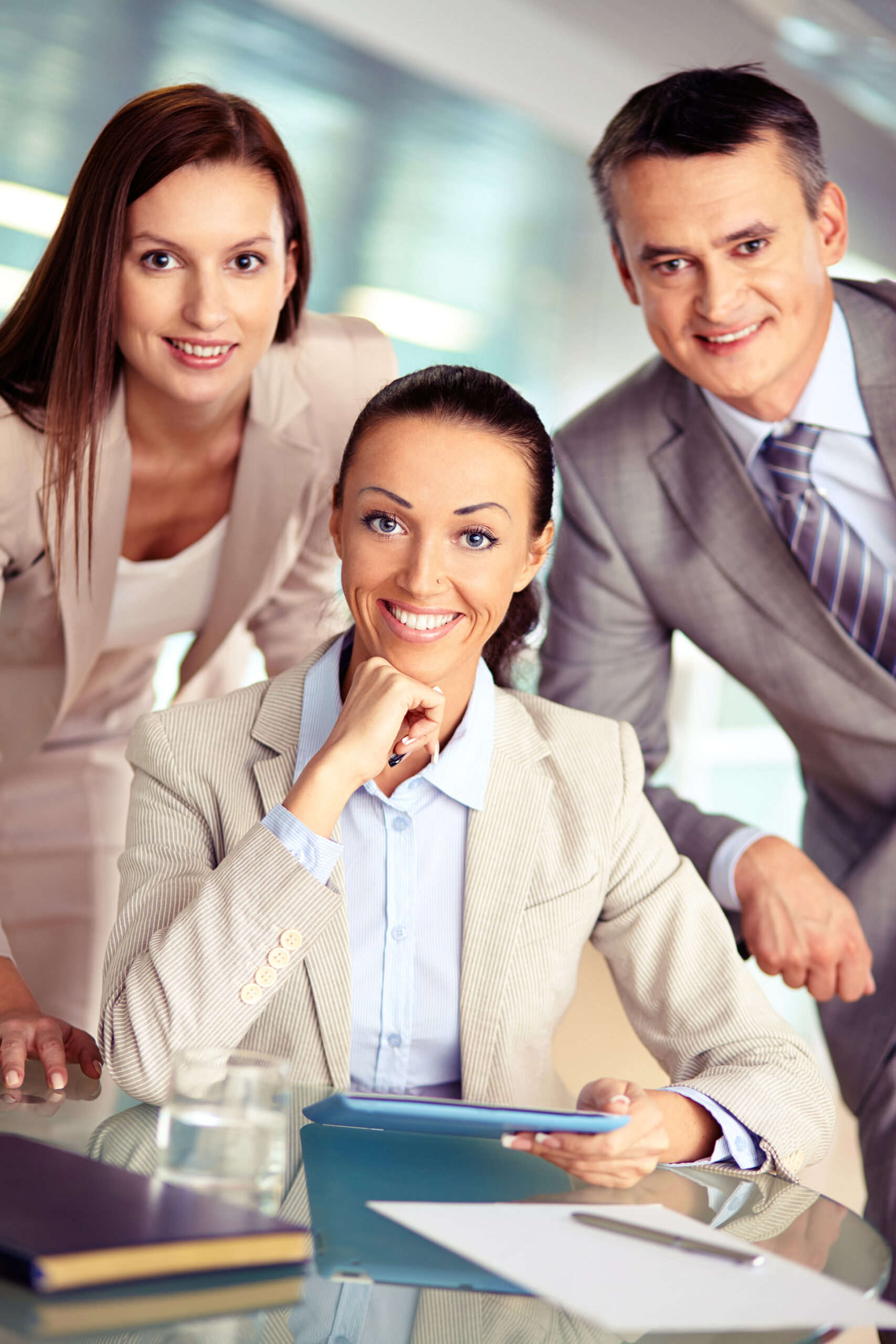 Portrait of three confident employees looking at camera