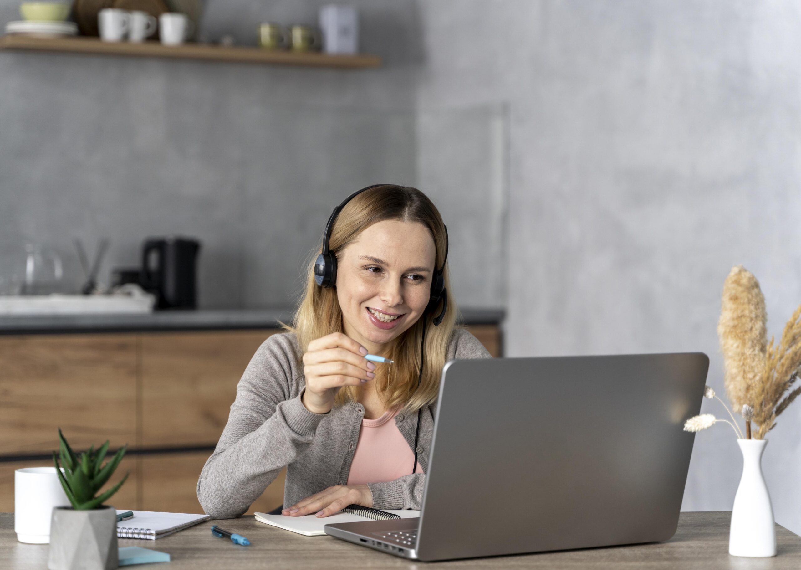 mujer-con-auriculares-trabajando-en-equipo-portatil