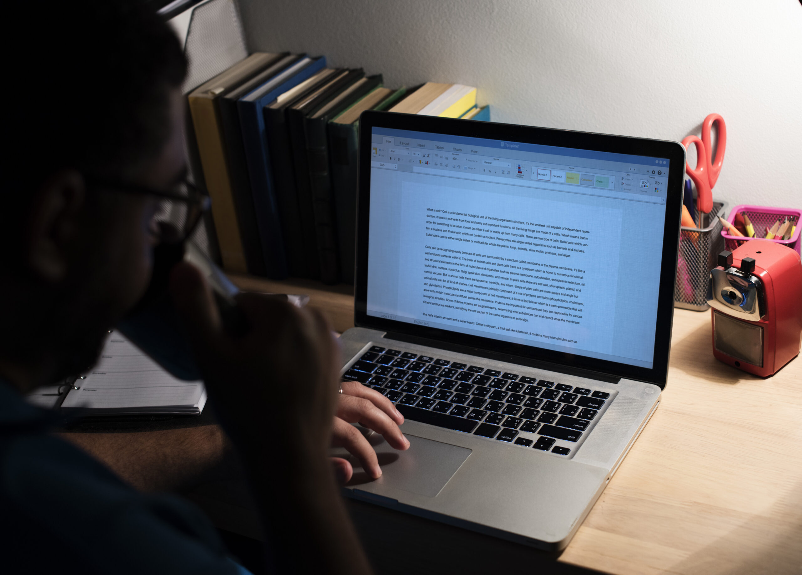 Man working in a home office with a laptop